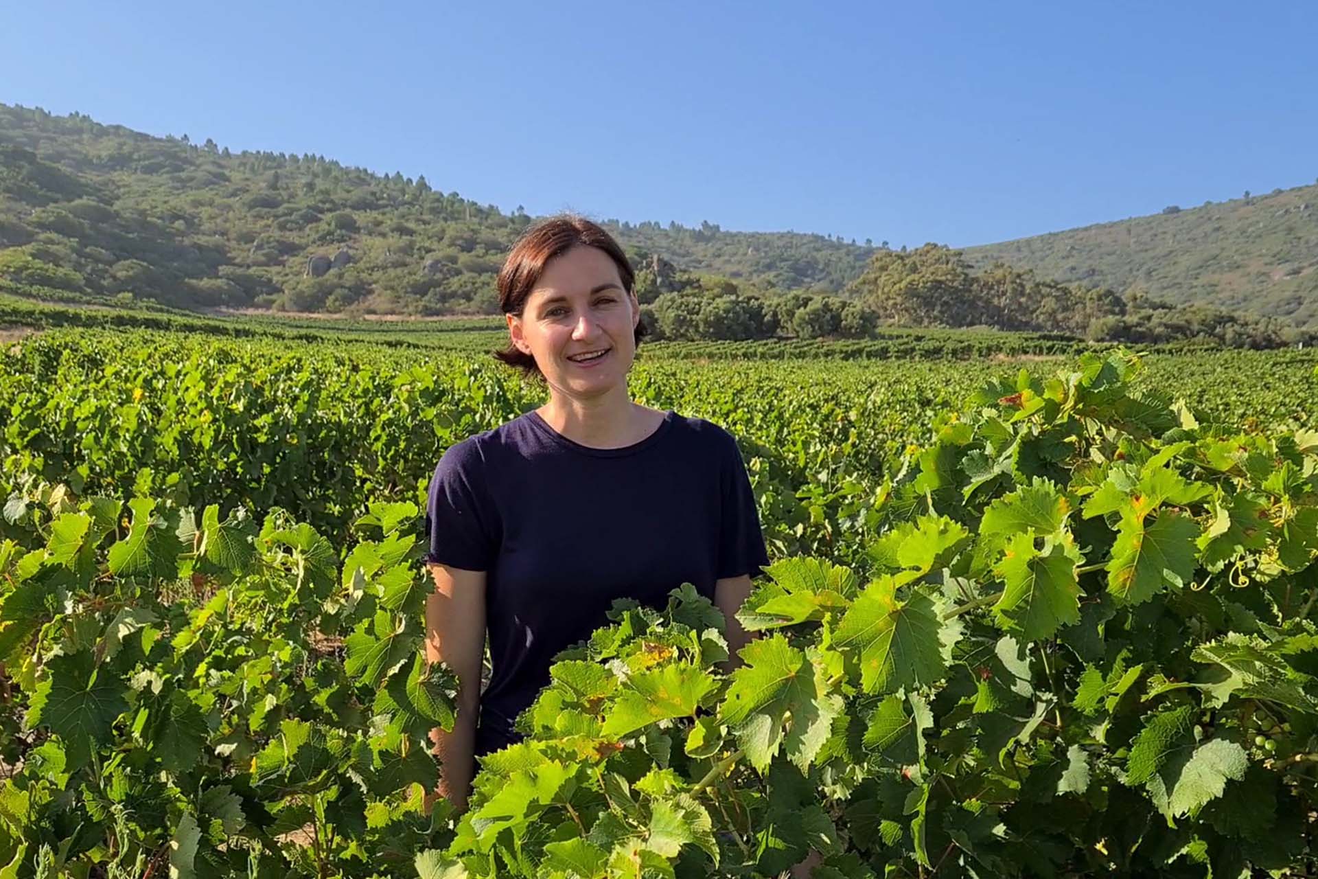 wine maker of rhebokskloof Rolanie lots standing in the vineyard smiling in one of the best wine farms in the paarl area