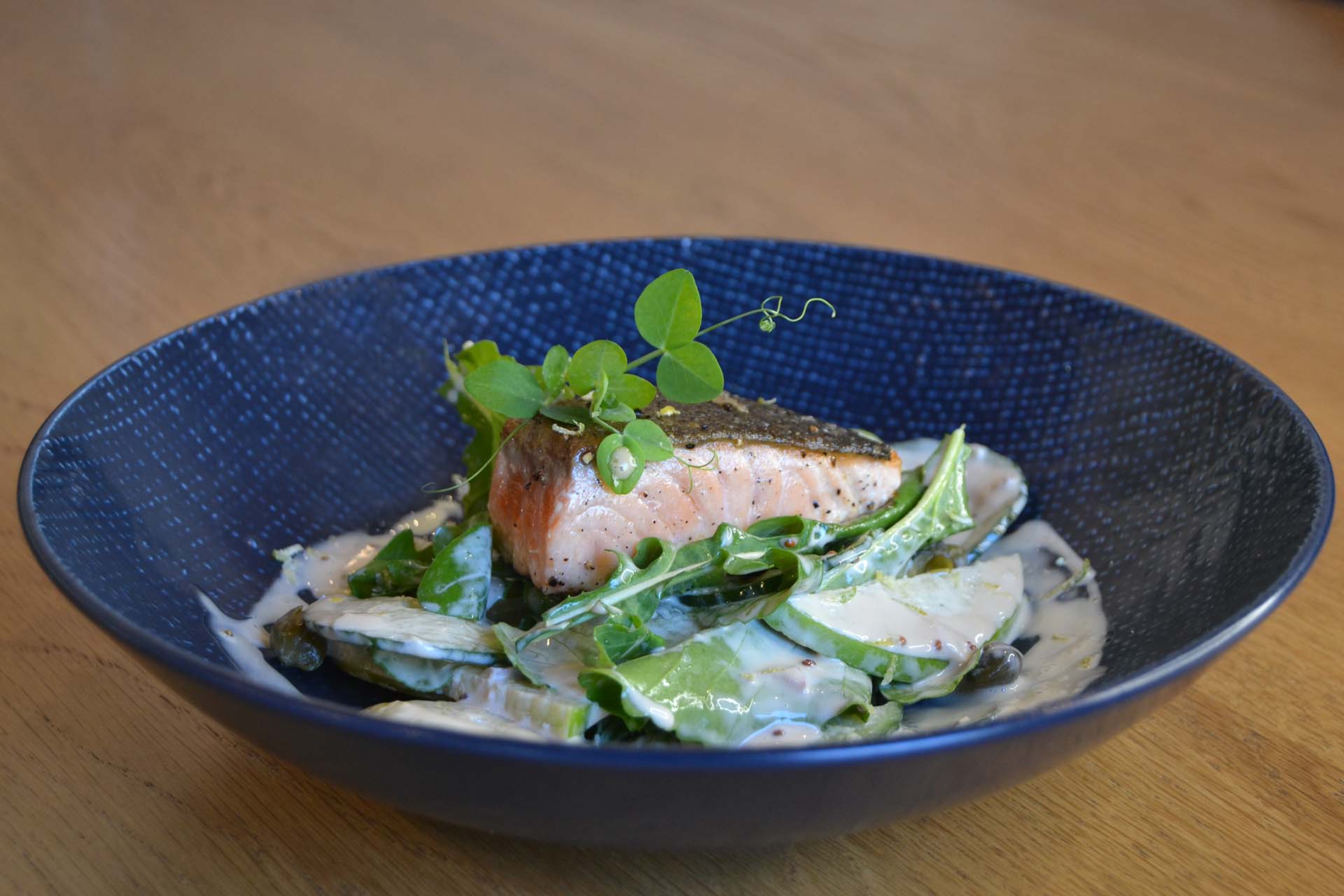 side view of a dish comprising of a rich salmon salad that offer a food an wine paring for a starter in winter