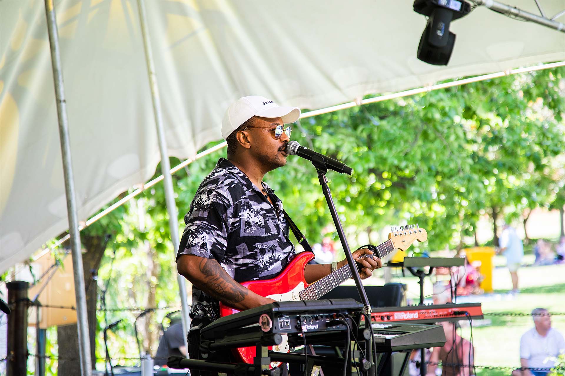 South African singer Majozi sings and plays guitar on stage at a music event around Cape Town called the Flatrock Music Festival