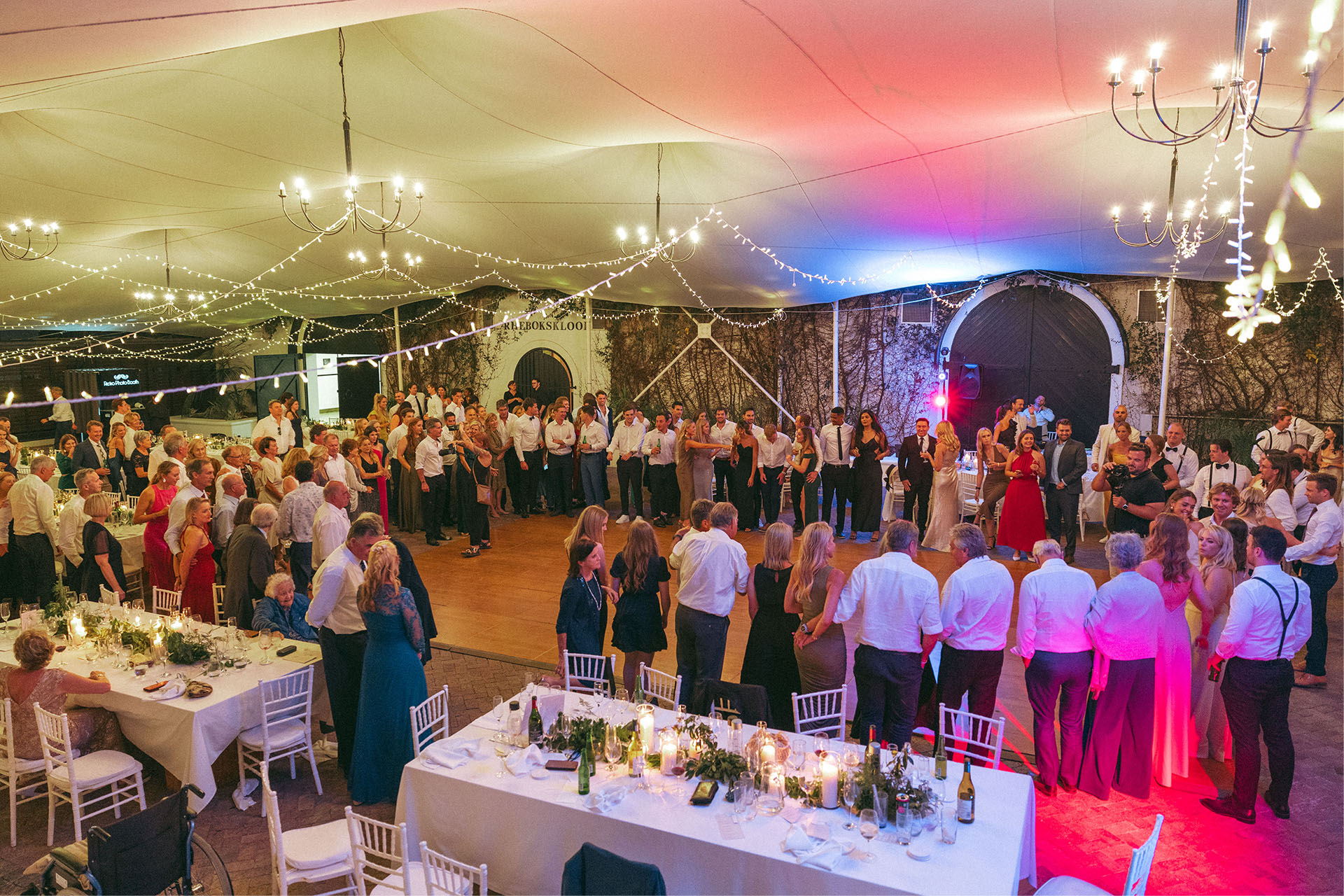 wedding guests get up to dance and have fun in the Rhebok reception venue which also offer a romantic garden wedding venue look and feel.